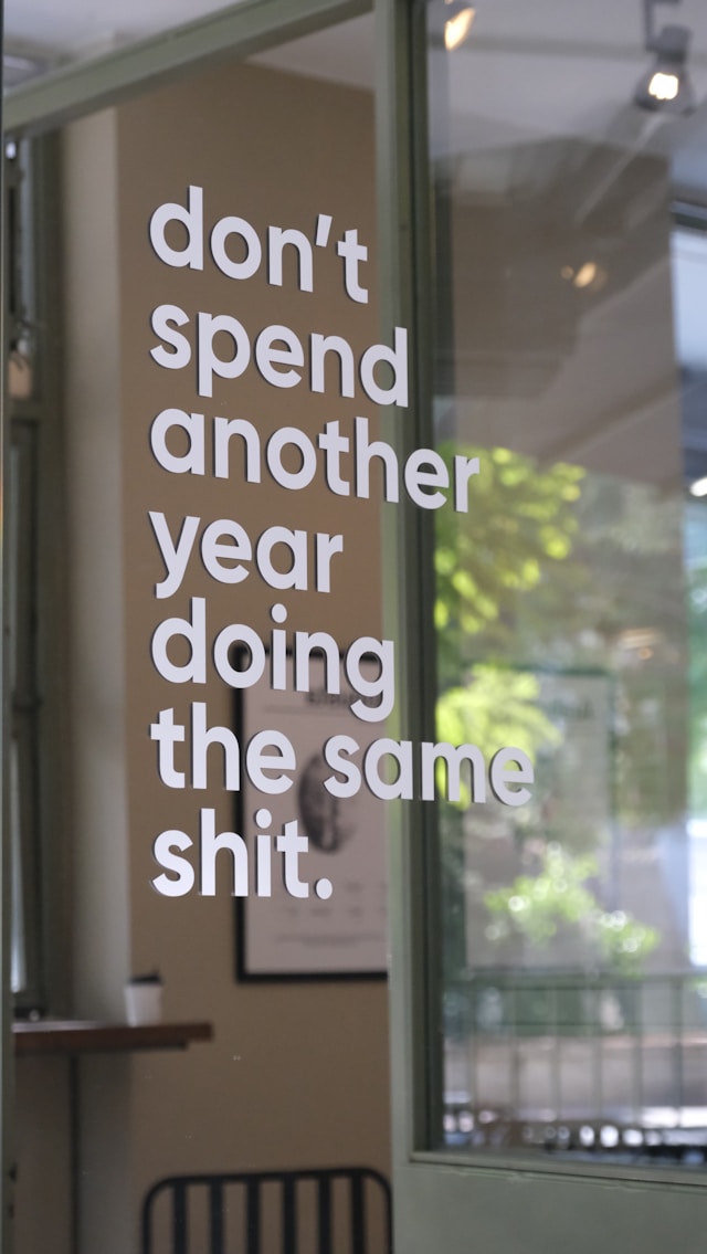 A person sketching a website layout on paper, focused on design elements and structure.